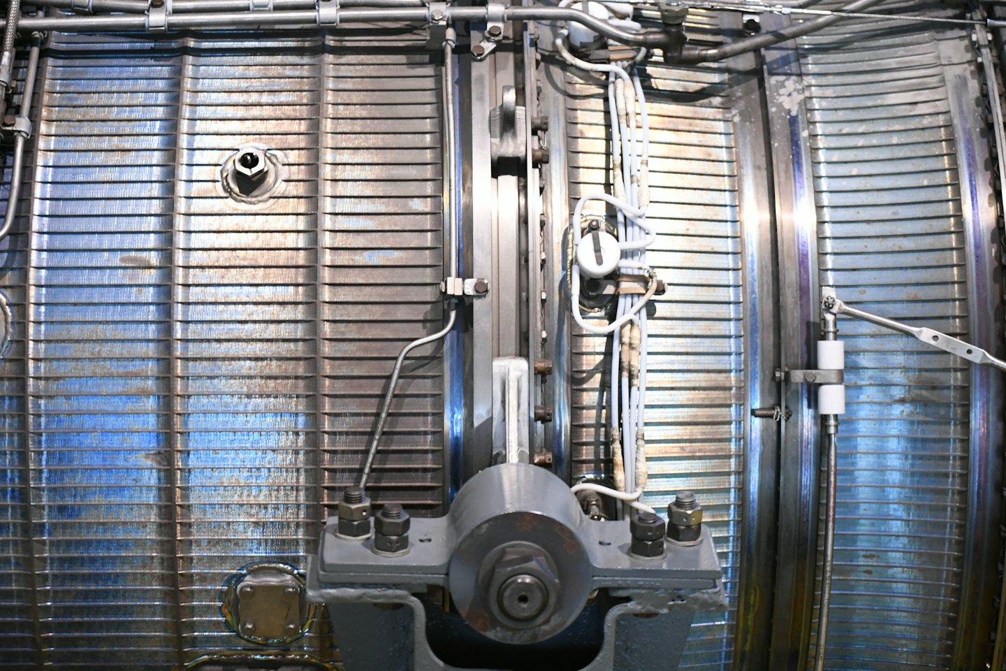 Intricate network of metallic pipes and industrial machinery parts.